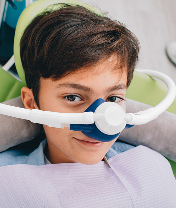 Child in dental chair with tube over nose