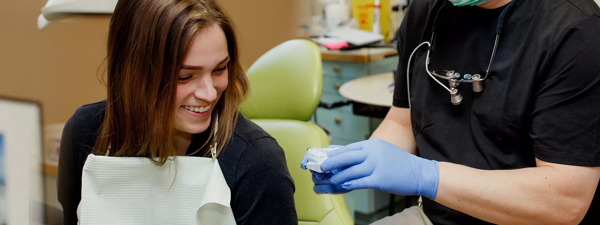 Dentist showing dental model to patient